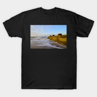 Wooden groynes on the sandy beach on the Norfolk coast T-Shirt